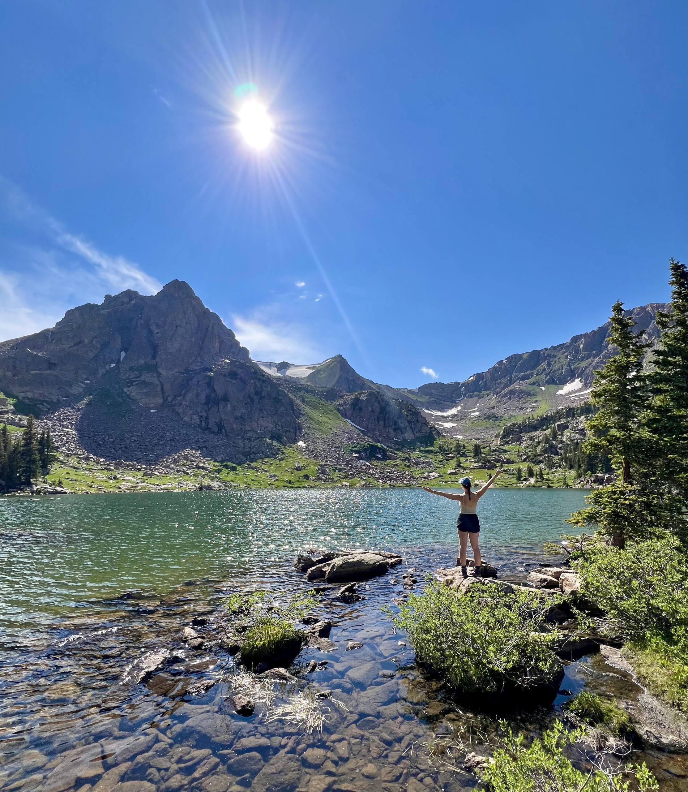 Lauren Meskis smiles while overlooking the scenic Vail Valley, surrounded by nature.